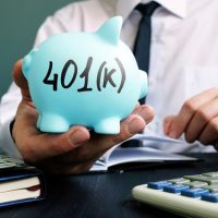 Man,proposes,piggy,bank,with,sign,401k.,retirement,pension,plan.