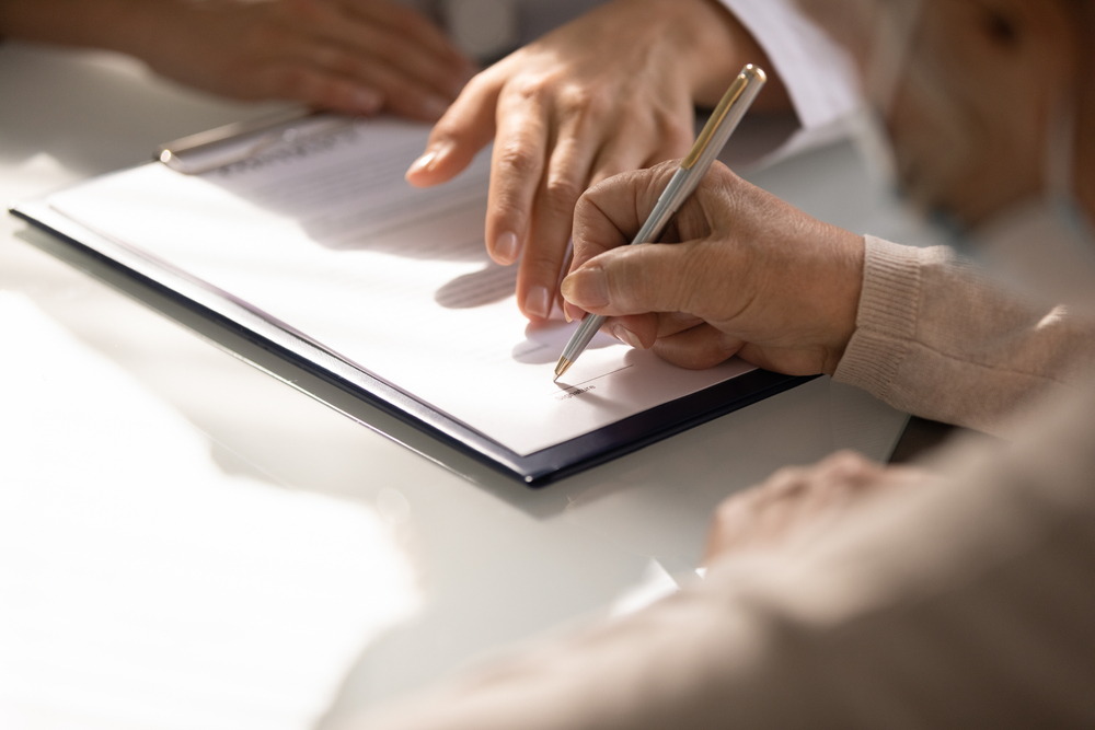 Commercial,medicine.,close,up,of,aged,woman,patient,hand,signing