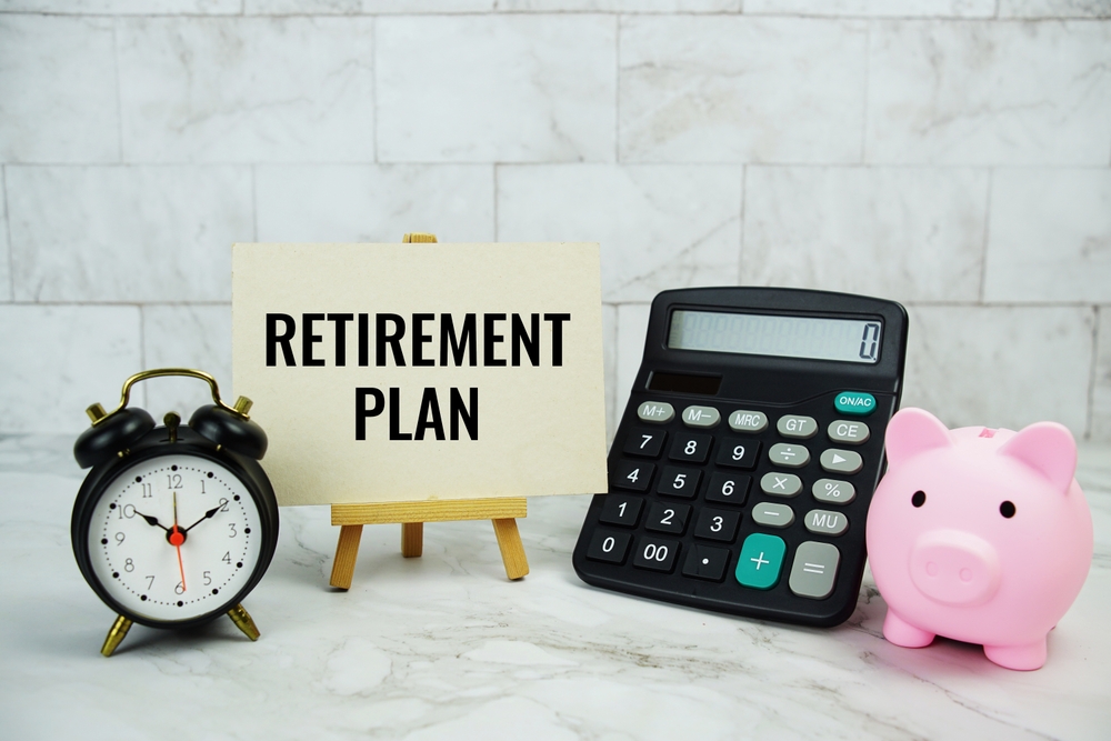 Retirement,plan,text,written,on,paper,card,with,piggy,saving,