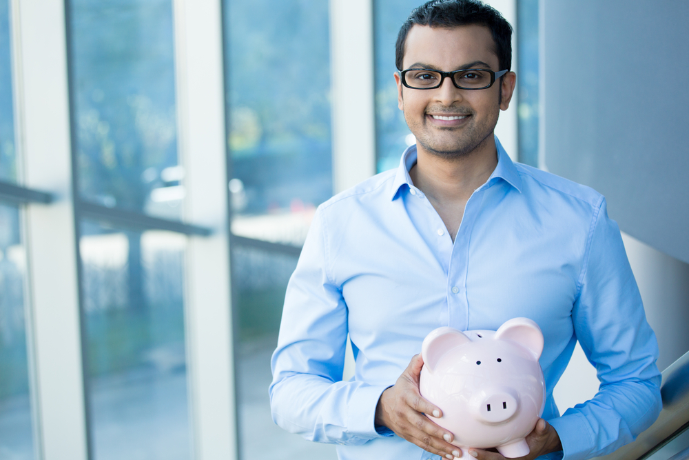 Closeup,portrait,happy,,smiling,businessman,with,black,glasses,,holding,pink